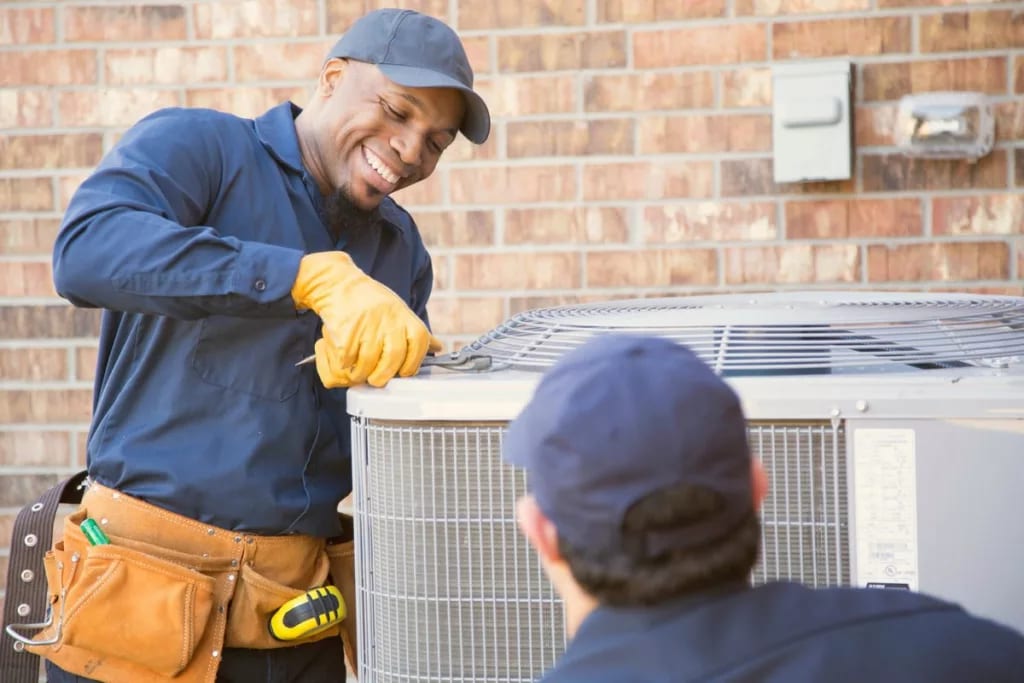 HVAC technicians servicing an outdoor unit wa.width .jpg