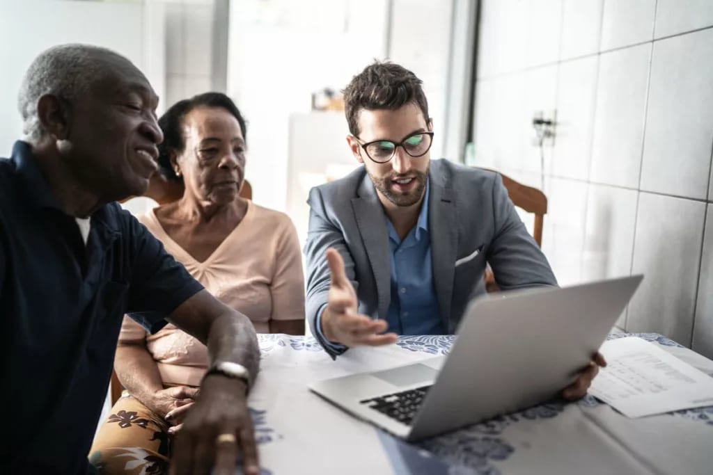 Senior couple meets with male professional. y.width .jpg