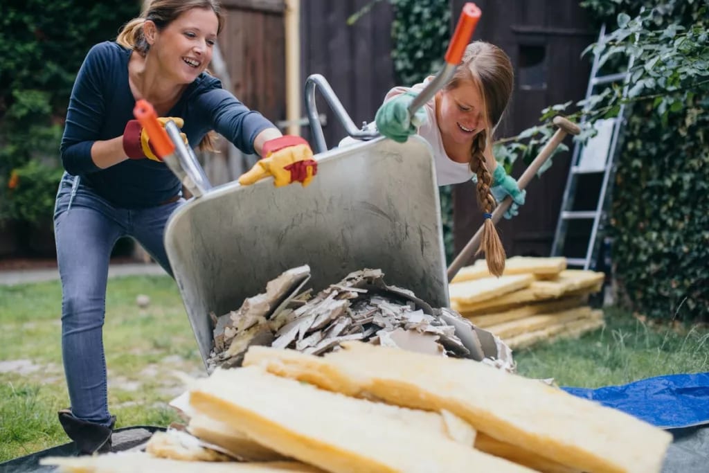 Two women dumping home renovation scraps in a.width WSoZror.jpg