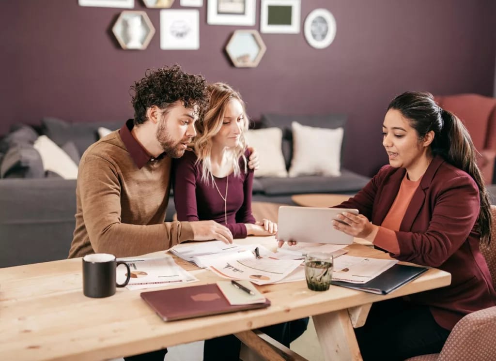 Young couple meets with professional woman v.width .jpg