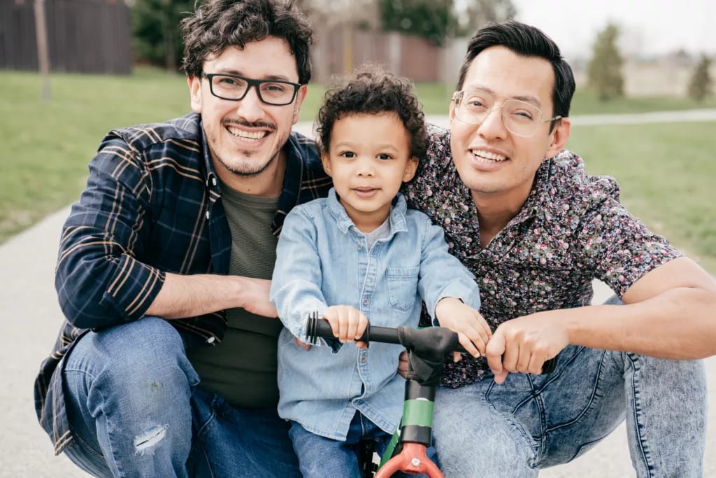 getty happy couple posing outside with child.jpg