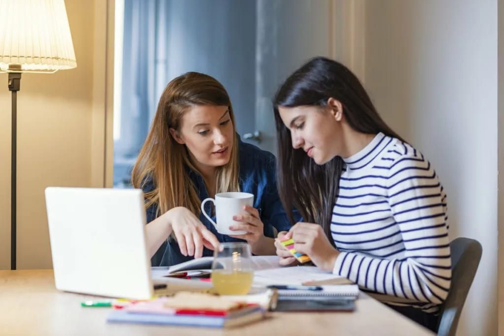 mom and teen daughter do homework.width .jpg