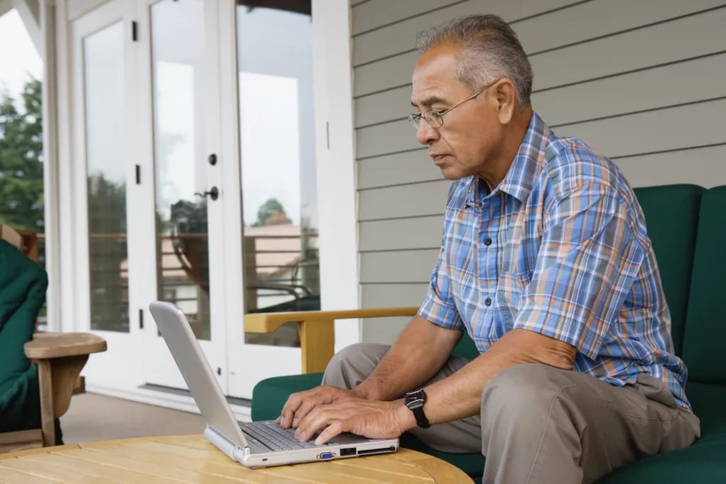 older man laptop outdoors gettyimages .jpg