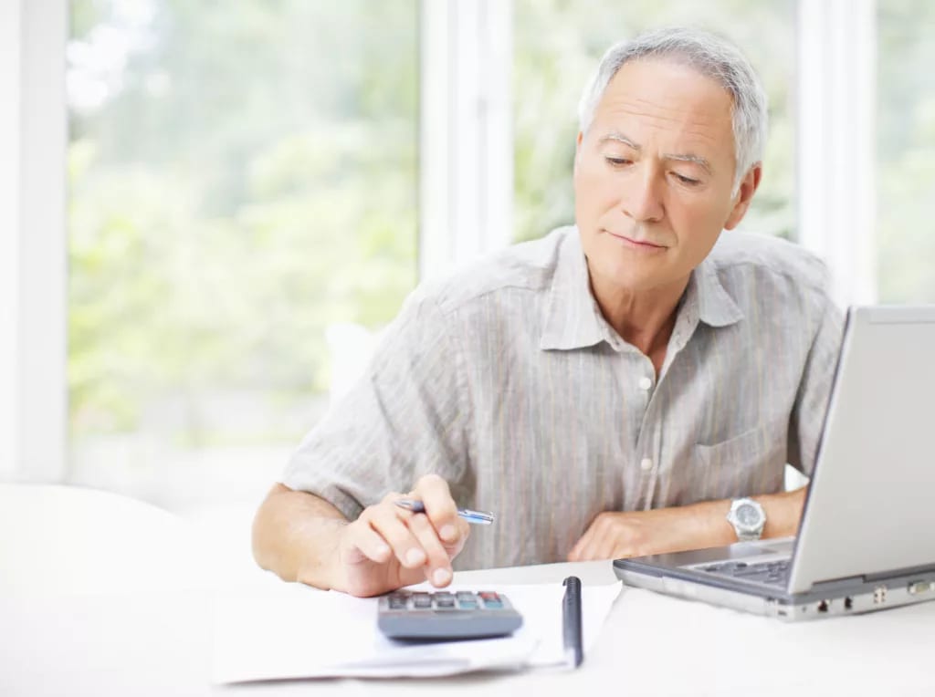 senior man using calculator gettyimages .jpg