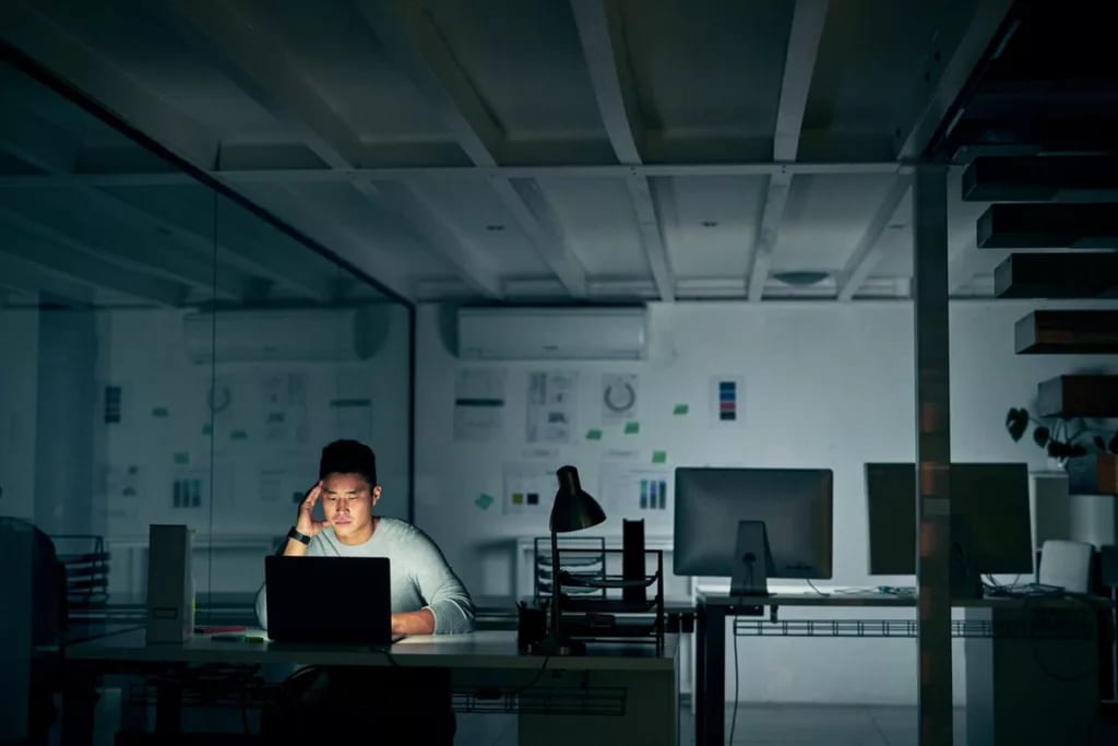 stressed man on computer in dark office qNpmh.width .jpg