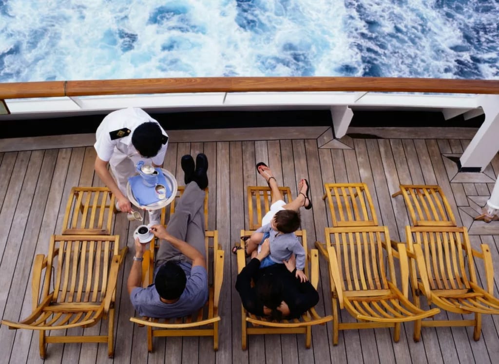 Server bringing family drinks as they lounge .width .jpg