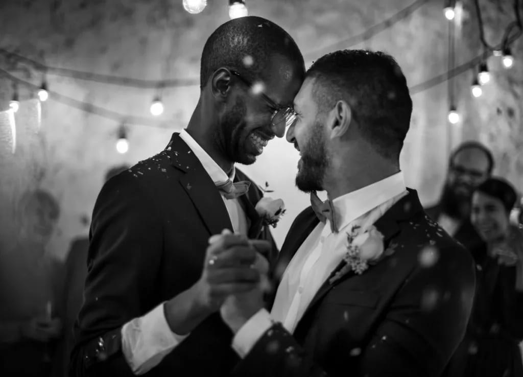 Smiling men dancing at their wedding fexRG.width .jpg