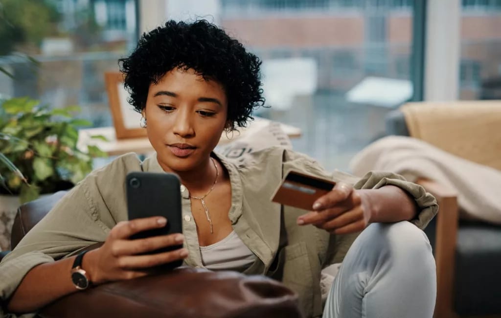 Young woman pays for online purchase with cre.width uHthJ.jpg