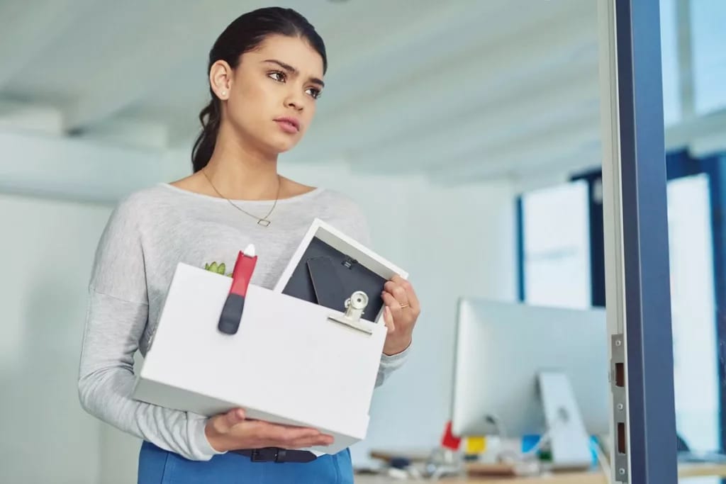 fired woman leaving office with box of things.width .jpg