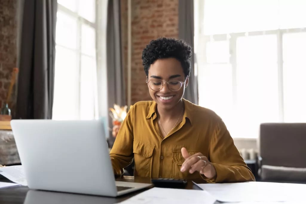 investor smiling computer getty images download from fool brandfolder.jpg