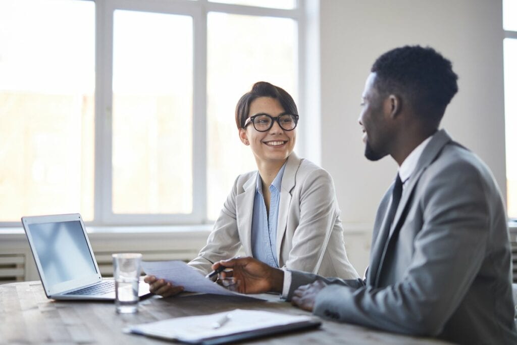 man and woman in business attire sitting at t.width kcfQTZ.jpg