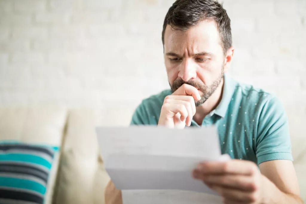 man looking at paper gHuSMY.width .jpg