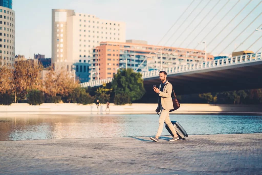 man with suitcase walking outside.width .jpg