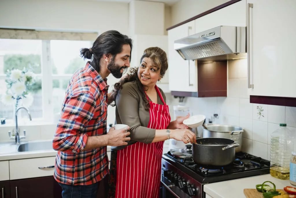mother with adult child cooking TwZGVpz.width .jpg