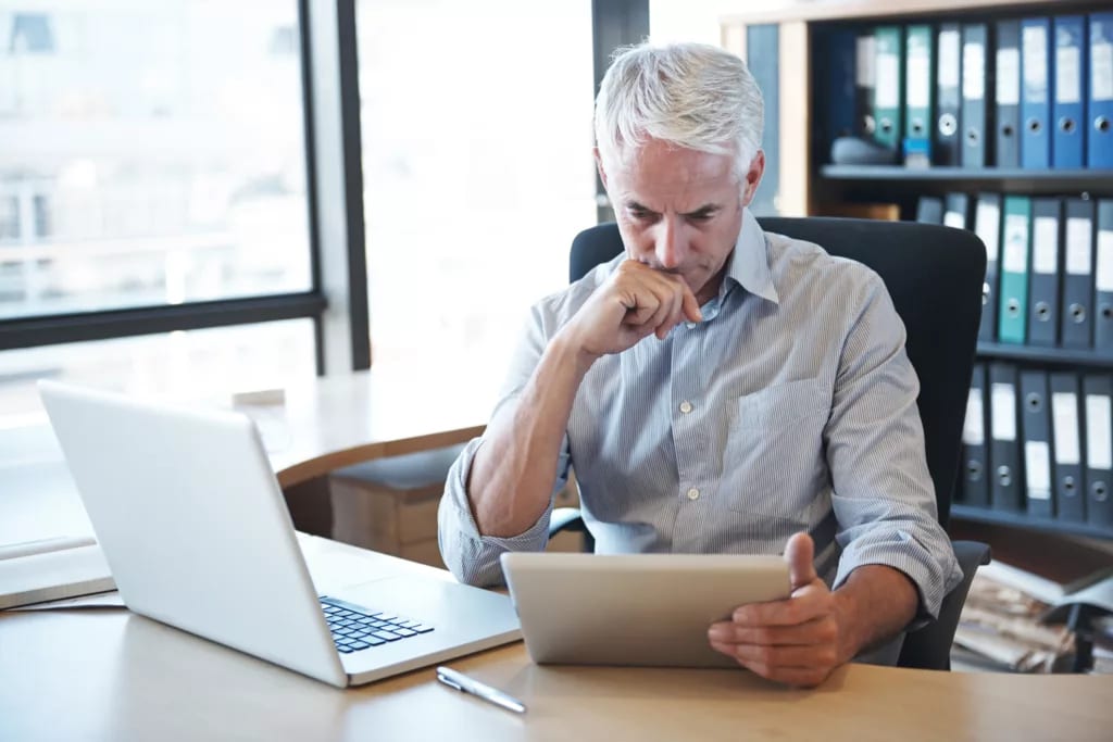 older man desk tablet serious gettyimages .jpg