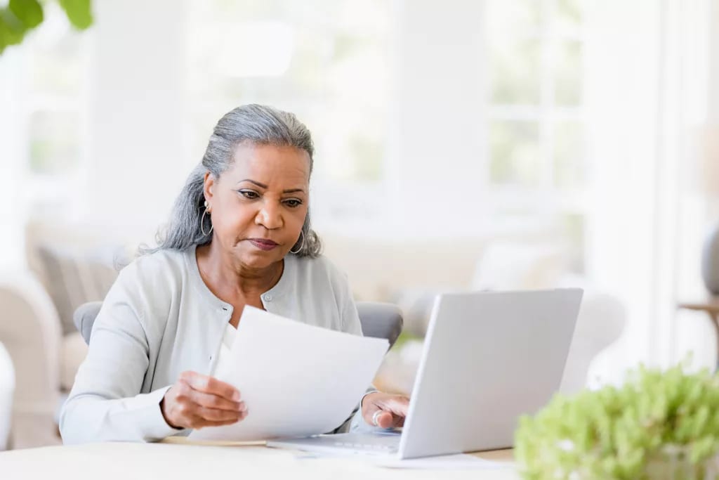 older woman document laptop gettyimages .jpg