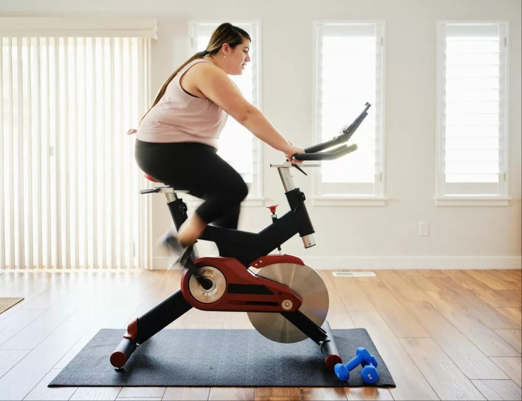 person on exercise bike at home kRawtlc.width .jpg