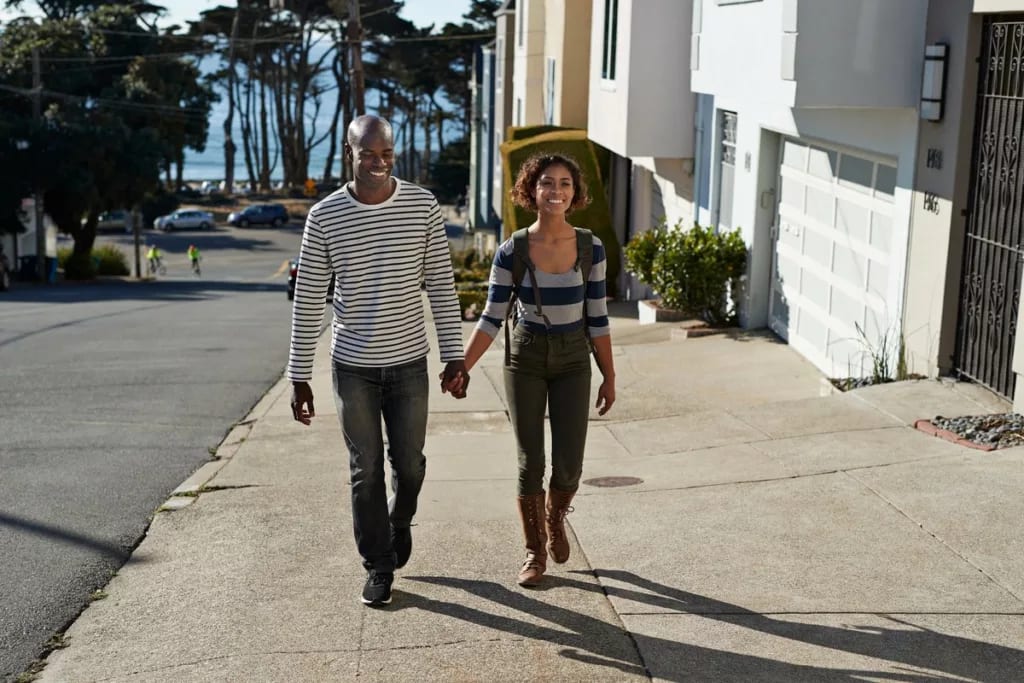 two people walking up hill with houses pVTutq.width .jpg