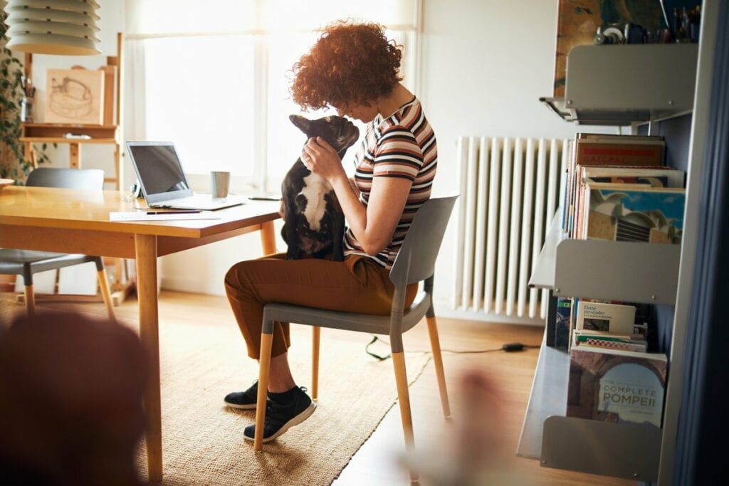 woman at desk with dog on lap cLXvUl.width .jpg