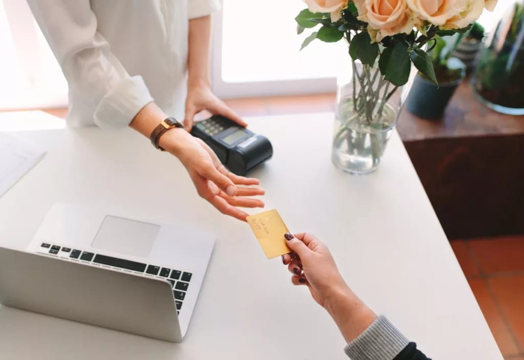 Handing credit card to swipe at store FrNRu.width .jpg