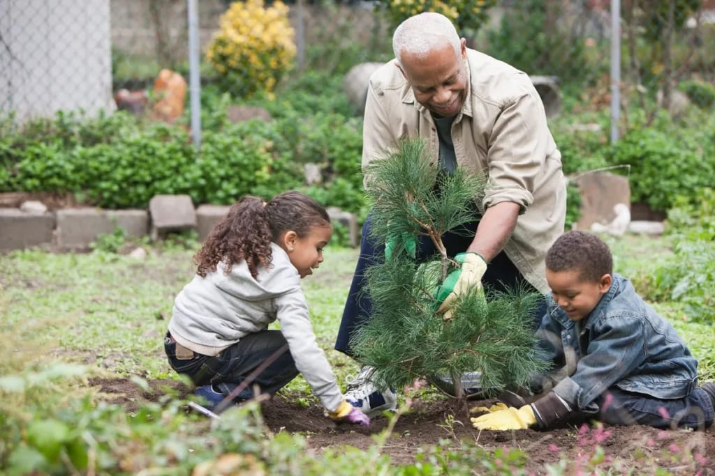 adult and two kids planting tree tKgvKn.width .jpg