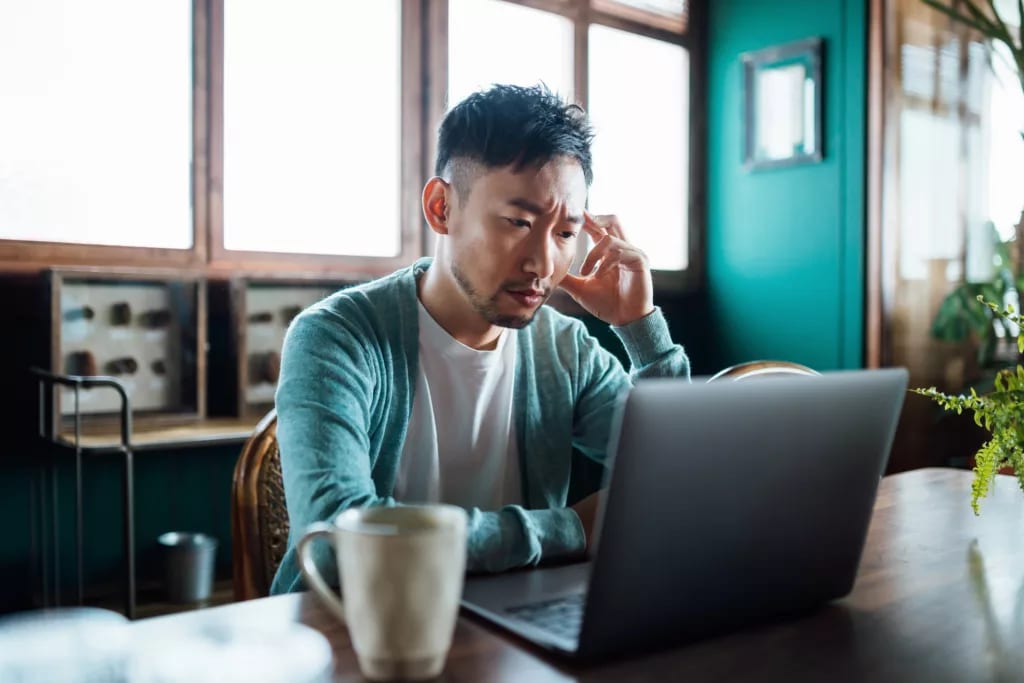 concerned unhappy person staring at laptop.jpg