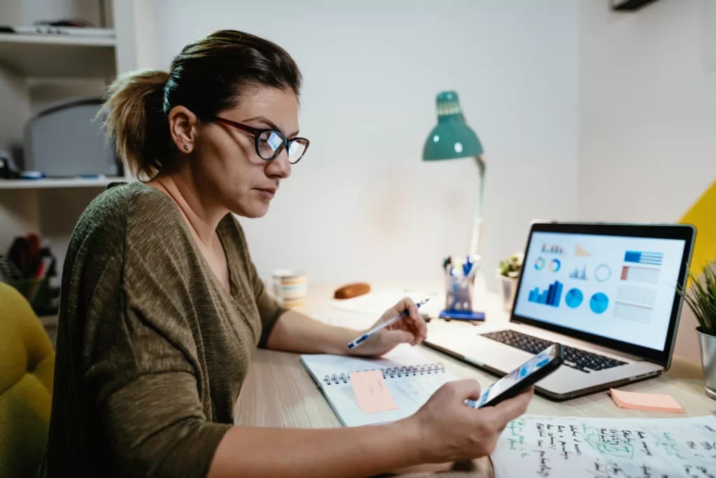 female investor reviewing her portfolio on a laptop.jpg