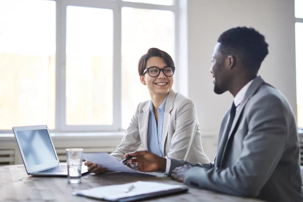man and woman in business attire sitting at t.width wTRpQTC.jpg