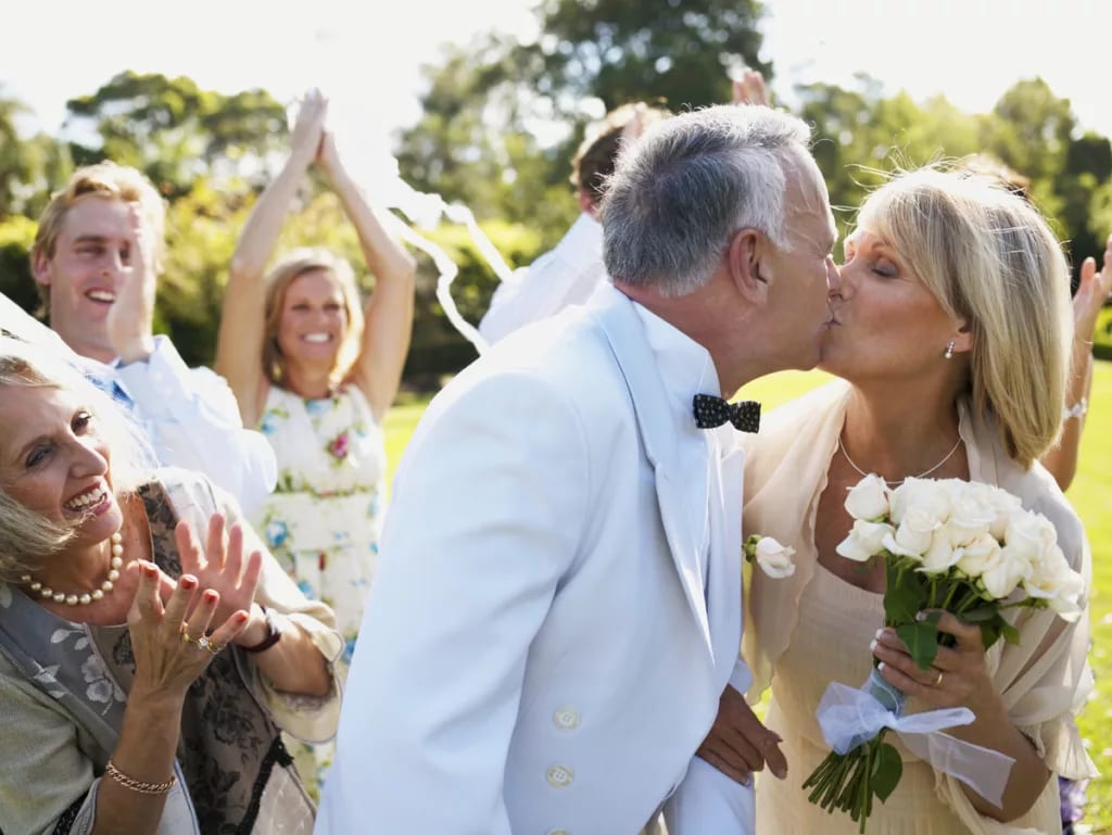 mature couple getting married kiss with bouquet x cbe.jpg