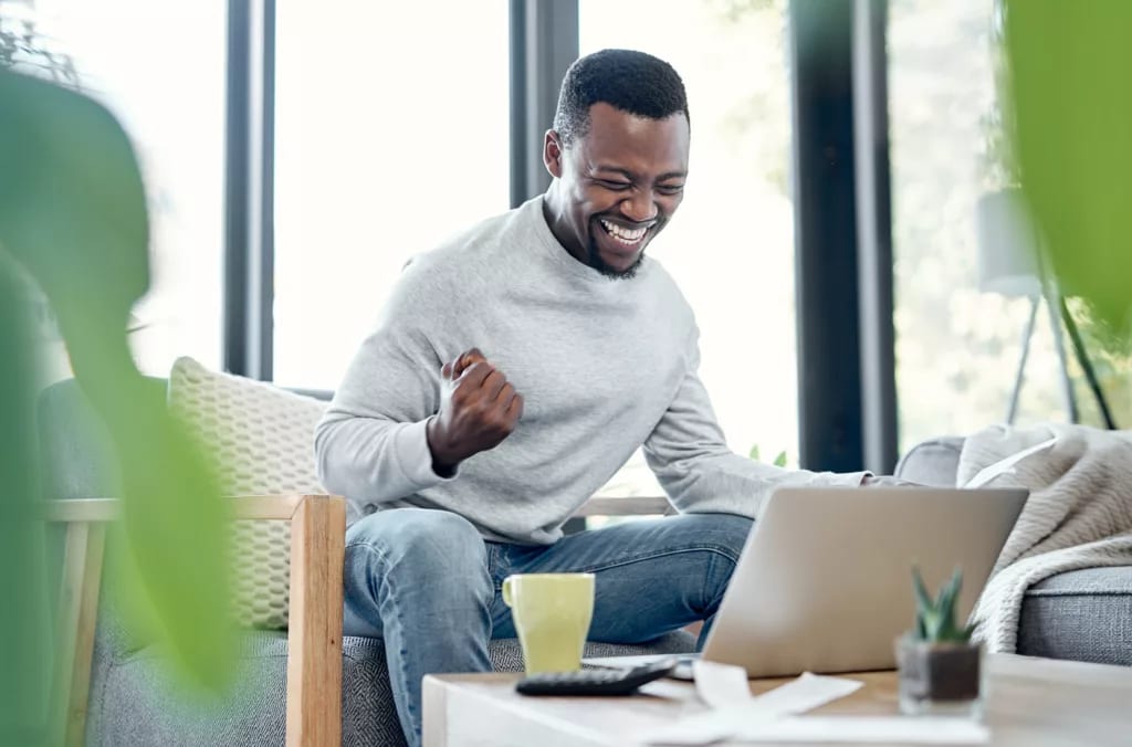 person celebrating success on laptop .jpg