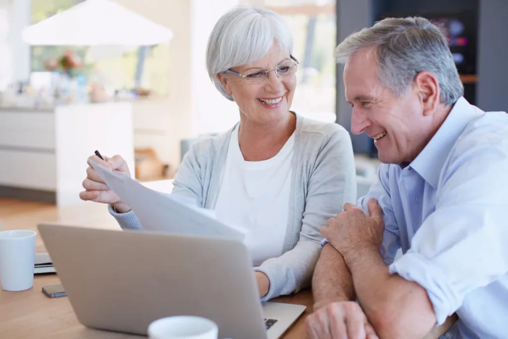 senior couple smiling laptop gettyimages .jpg