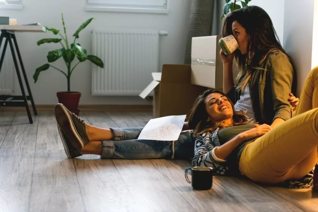 two women sitting on floor.width .jpg