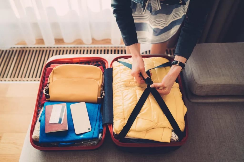 woman packing suitcase with credit card on to.width iPxUbne.jpg