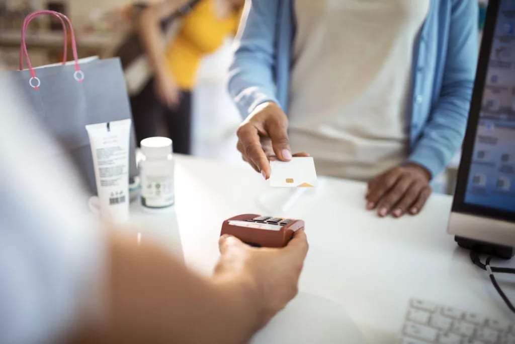 woman paying with credit card at pharmacy SRR.width .jpg