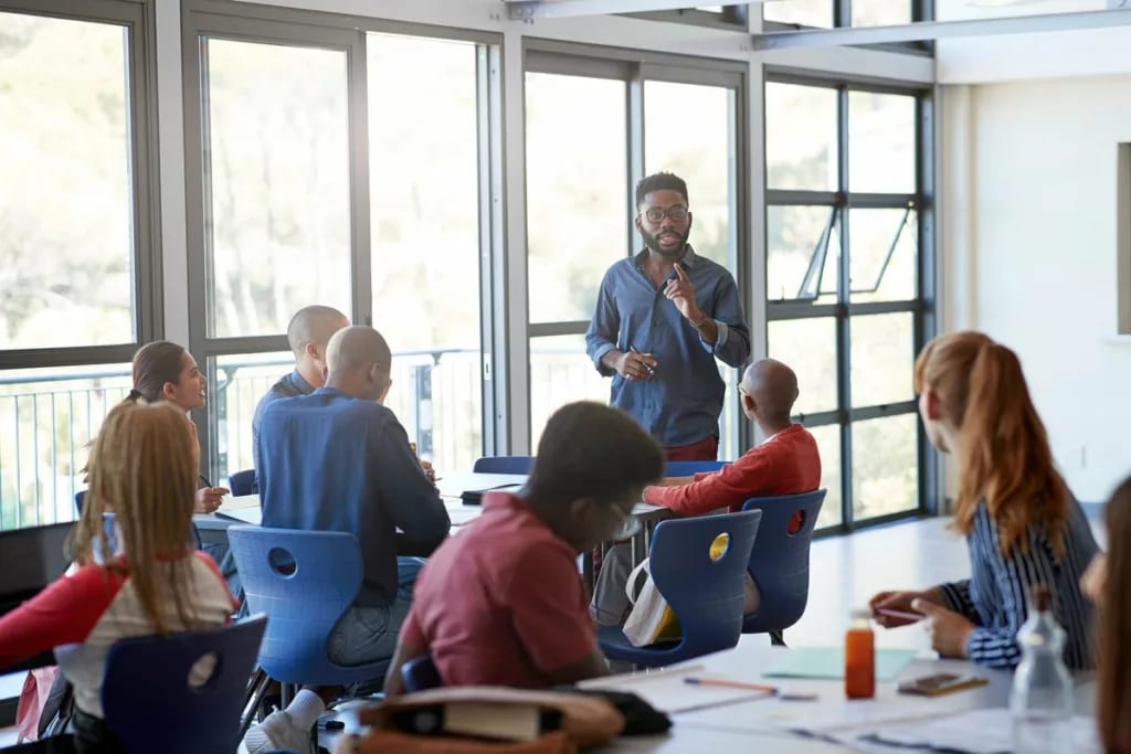 Young adult male speaking to students in clas.width eZlvXFB.jpg