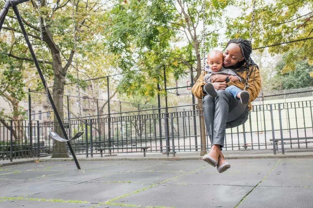 Young mother with infant at city park. AbbKi.width .jpg