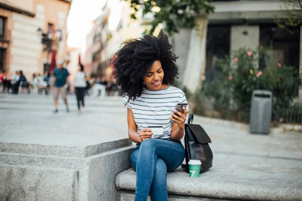 Young woman makes an online purchase while si.width equBkZ.jpg