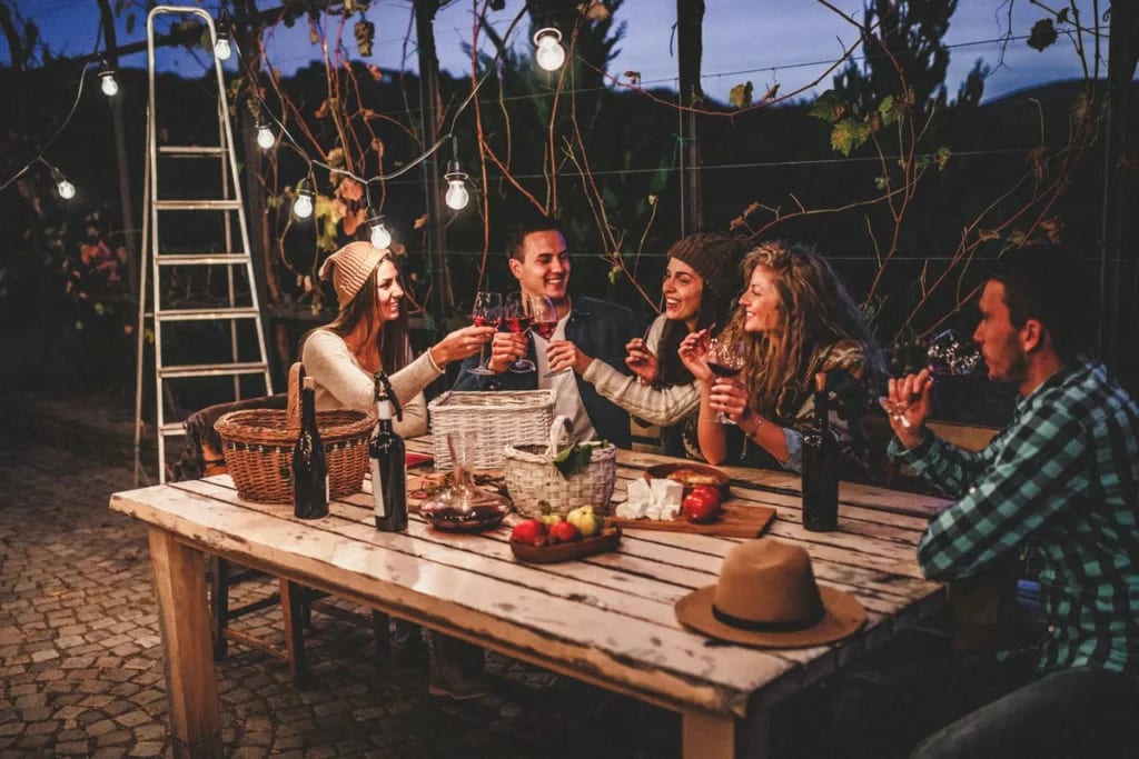friends drinking wine at backyard table.width .jpg