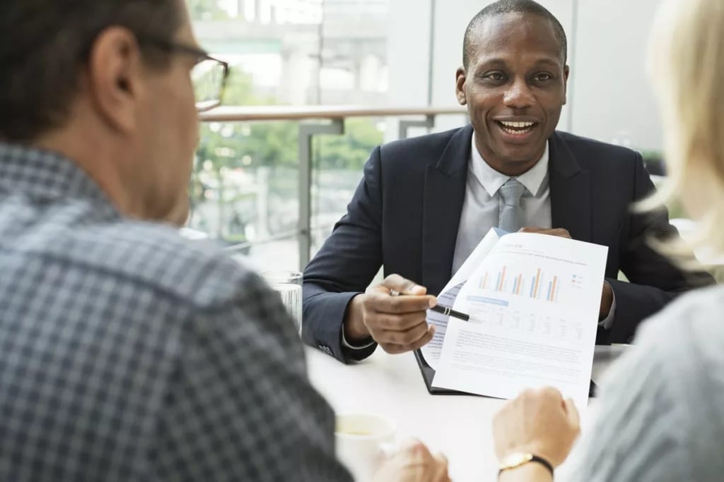 mature couple talking to financial advisor PO.width KFkW.jpg
