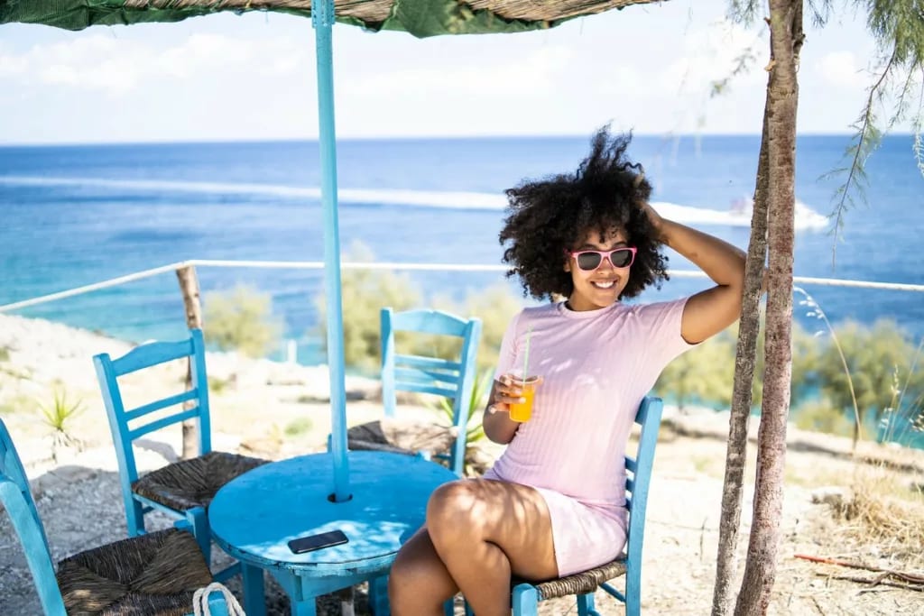 person with drink at table with tropical ocea.width .jpg