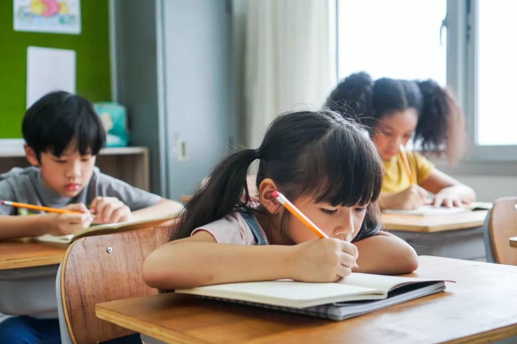 three young kids in classroom BgNhPc.width .jpg