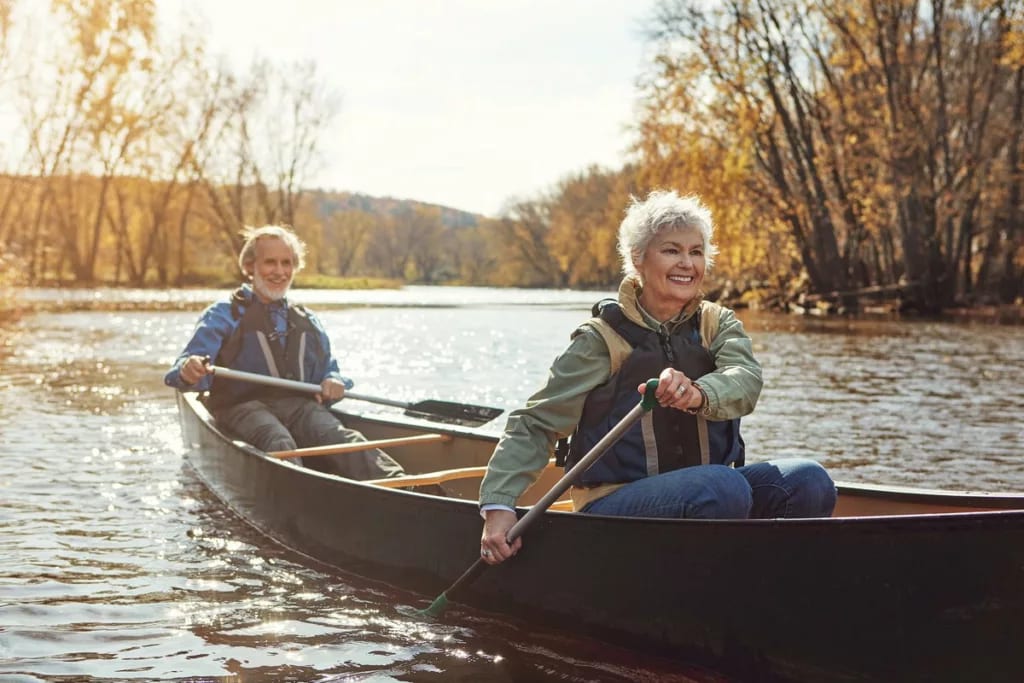 Mature couple rowing together in a canoe aaF.width .jpg