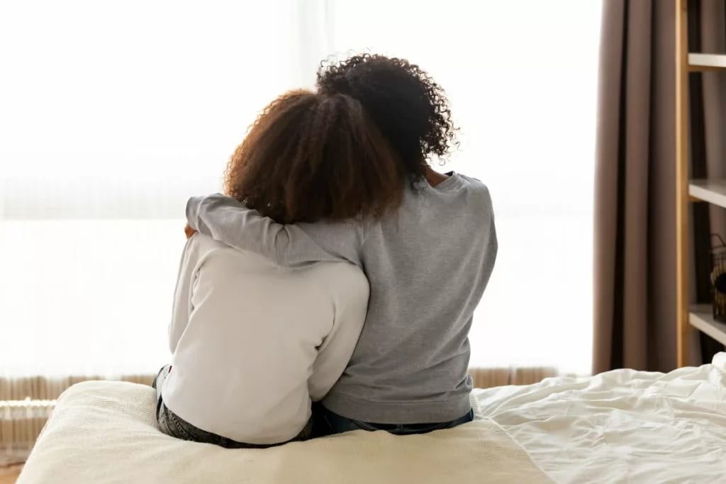 Mother daughter sitting on bed RVrqggy.width .jpg