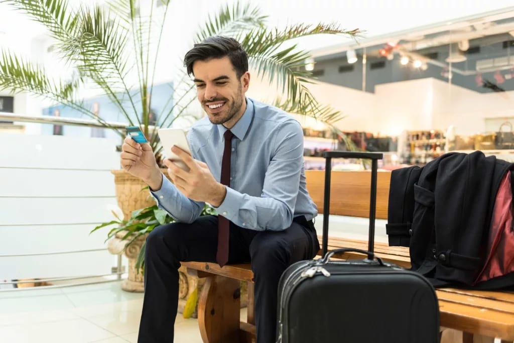 Traveler at airport with luggage phone and cr.width .jpg