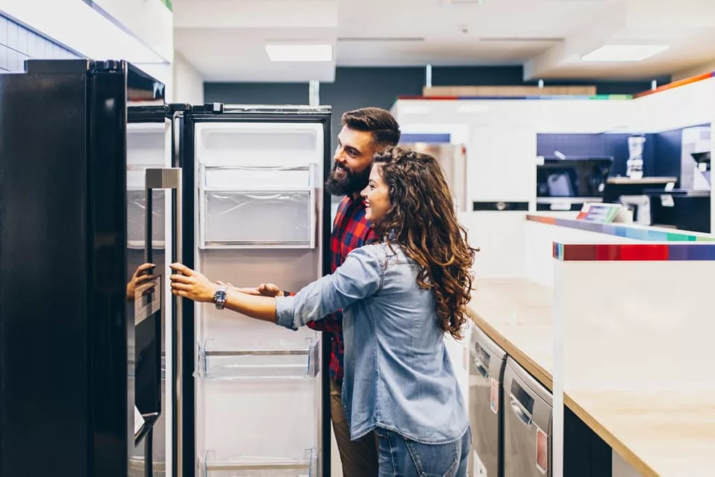 Young couple shopping for fridge.width .jpg