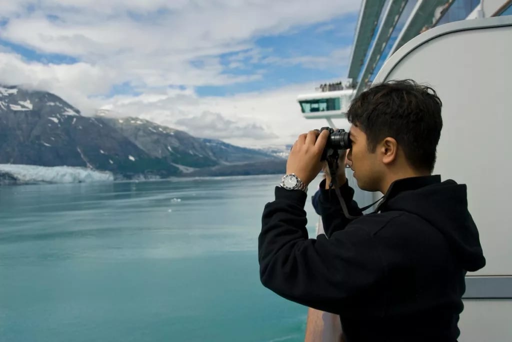 Person using binoculars on cruise ship GdSIfW.width .jpg