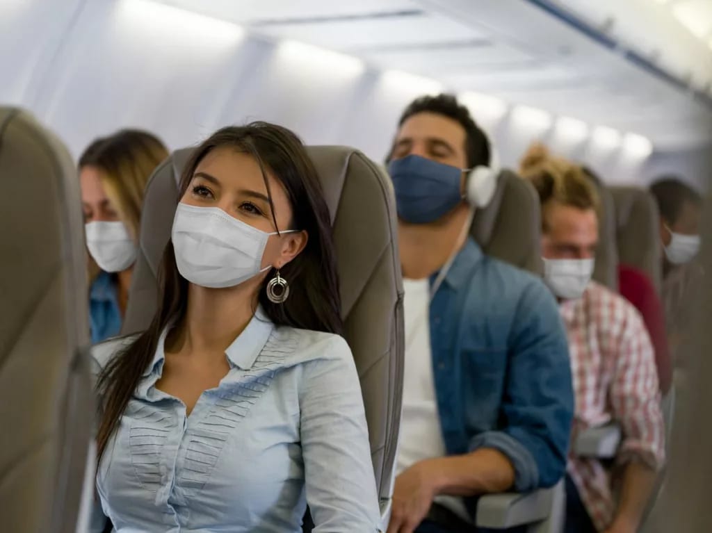 Masked passengers on a plane GaAbt.width .jpg
