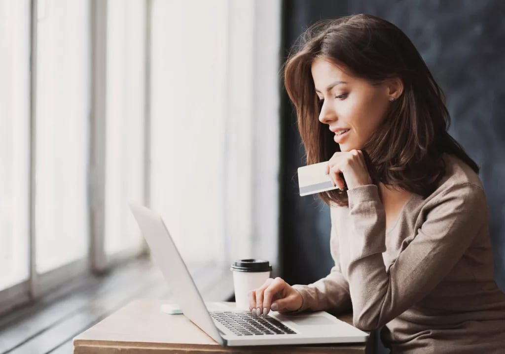 Woman on laptop with credit card BLbaw.width .jpg