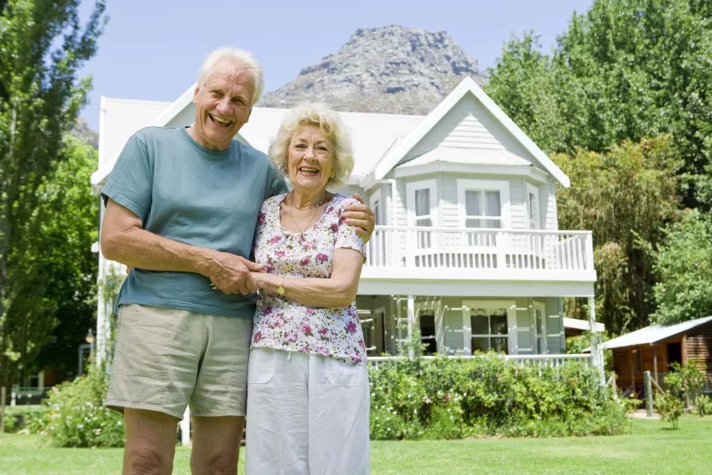 senior couple outside of larger home gettyimages .jpg