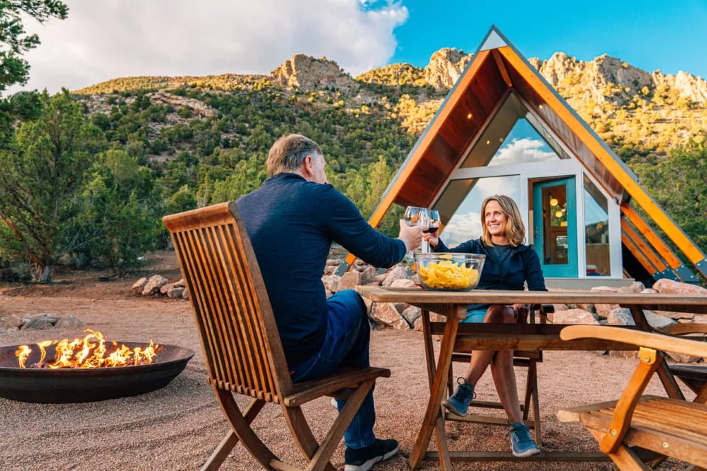 couple toasting over table outside house.jpg